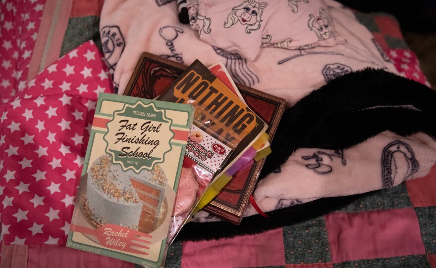 Books by poet Rachel Wiley lay scattered on a bed in Camp Roundup's bunks on Labor Day weekend.