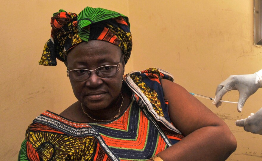 A woman is vaccinated at a health center in Conakry, Guinea, during the clinical trials of a vaccine against the Ebola virus.