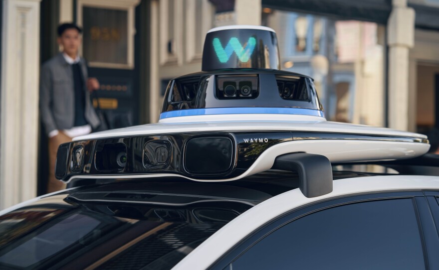 Sensors top the roof of a Waymo driverless taxi in this undated company photograph.