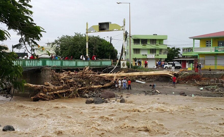 Rivers remained swollen and choked with debris in Roseau, Dominica, on Friday after Tropical Storm Erika had passed