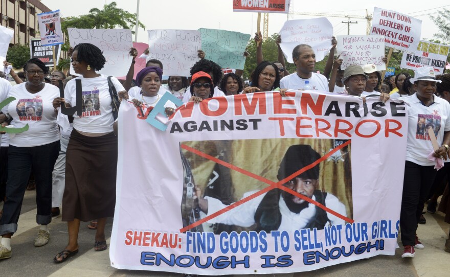 Demonstrators call for the release of girls kidnapped from a school in Nigeria, during a demonstration in Lagos Monday. A woman has said her daughter is in a video released by Boko Haram, the group that took the girls last month.