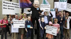 Demonstrators, one wearing a mask depicting Rupert Murdoch (center), holds puppets depicting British Prime Minister David Cameron (right) and British Culture Minister Jeremy Hunt (left) as they protest outside the Department of Culture Media and Sport in central London on Thursday to show their opposition to the proposed sale of BSkyB to Murdoch's News International.