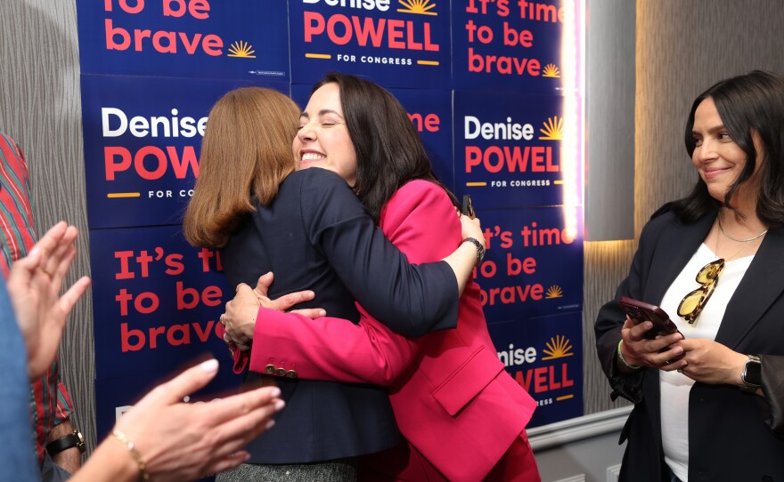 Denise Powell, candidate for the Democratic nomination to the House of Representatives in Nebraska's second district, right, hugs pollster Madeline Conway during an election night watch party Wednesday in Omaha, Neb.