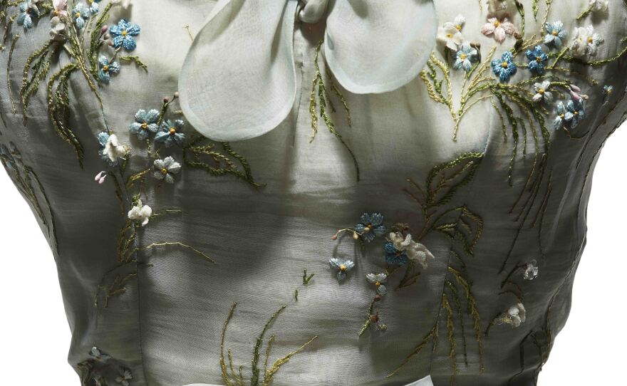 An afternoon dress in pale blue organdie, embroidered with pink and blue forget-me-nots, was part of Dior's spring-summer 1953 haute couture collection, Tulipe line.