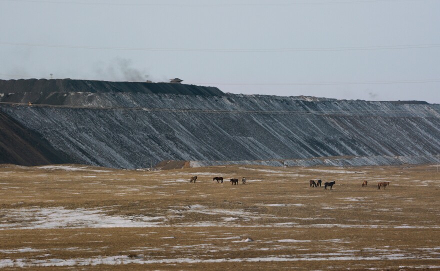 Horses graze in pastureland just outside one of Tavan Tolgoi's open-pit mines, where coal is being extracted for export.