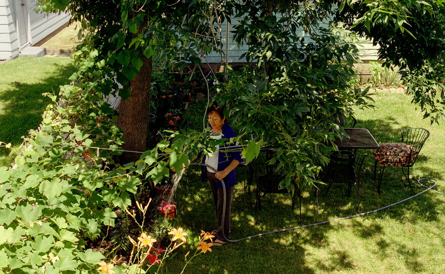 Teresa Chavez waters her garden in 2018.