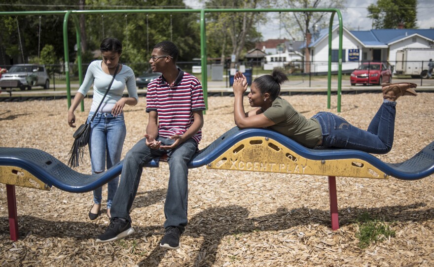 Gordon talks with friends Brittany Bloome (left) and Chanel Smith at a park down the street from the school. The seniors used their final block of the school day to get outside and pick up a late lunch from local businesses.