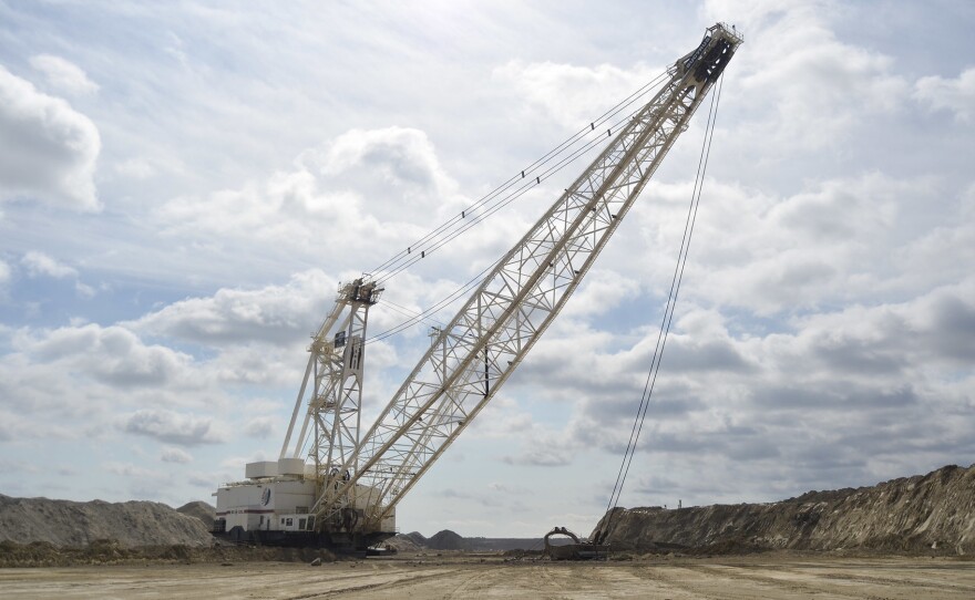 A dragline at the Center Mine in North Dakota removes dirt to expose layers of lignite coal. The coal is mined and transported to a power plant just a few miles away, where it's burned to generate electricity.