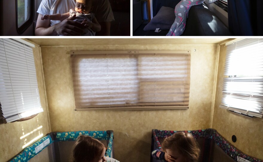 Top left: Noah holds 4-month-old Bishop in the bedroom of their RV in November. Top right: Riley looks out the window of their RV. Bottom: Harper and Riley, 2, wake up in their cribs. The Isaacses place an enormous value on family. It's the reason they are able to rebuild in an area that was ravaged by fires, and the reason they want to stay there in the first place.