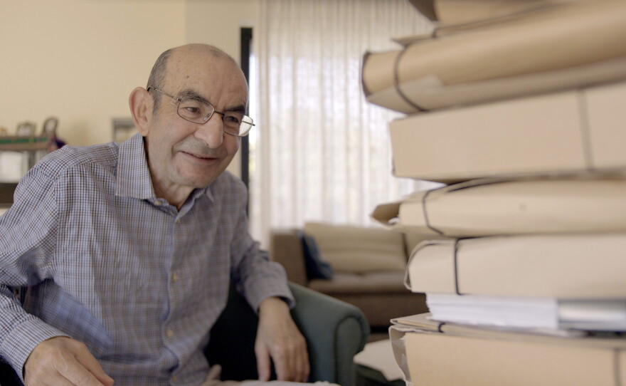 Raja Shehadeh looks at folders from his archive in 2026.