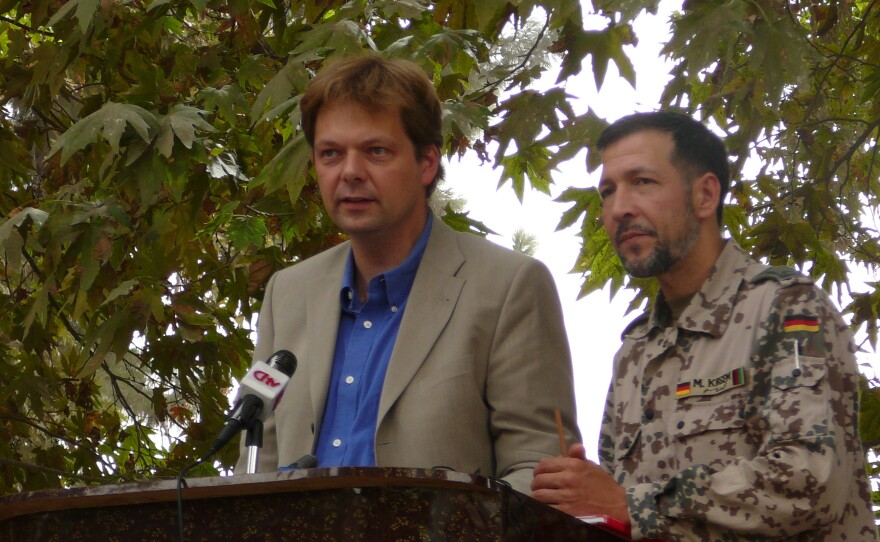 German official Philipp Ackermann gives a speech with military translator Mohamed Oda in 2006, while heading the Provincial Reconstruction Team.