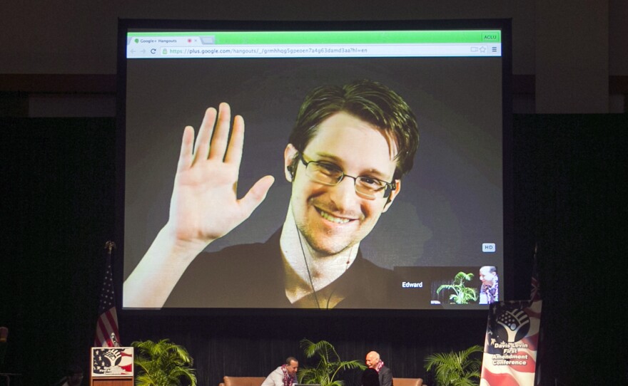 Edward Snowden appears on a live video feed broadcast from Moscow at an event sponsored by the ACLU Hawaii in Honolulu on Feb. 14, 2015.
