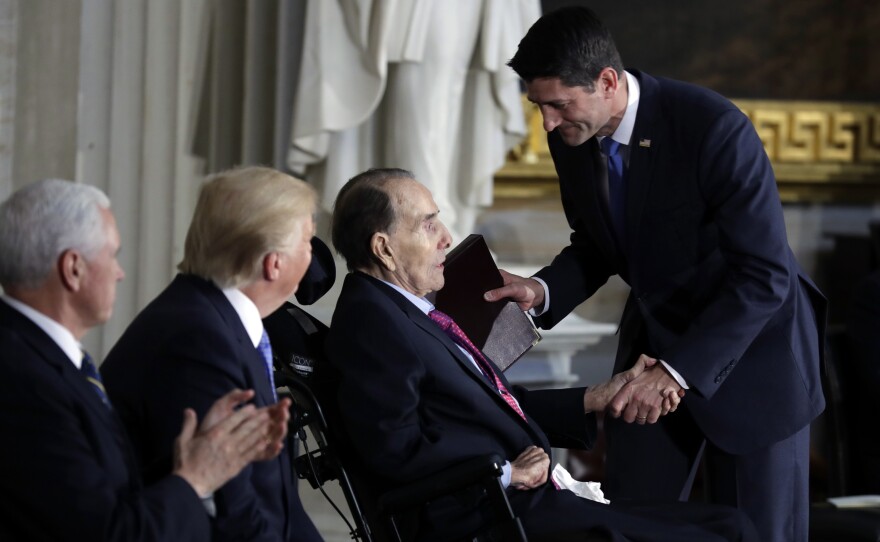 President Donald Trump and Vice President Mike Pence watch as House Speaker Paul Ryan of Wis., greets former Sen. Bob Dole during a Congressional Gold Medal ceremony honoring Dole on Capitol Hill Wednesday.