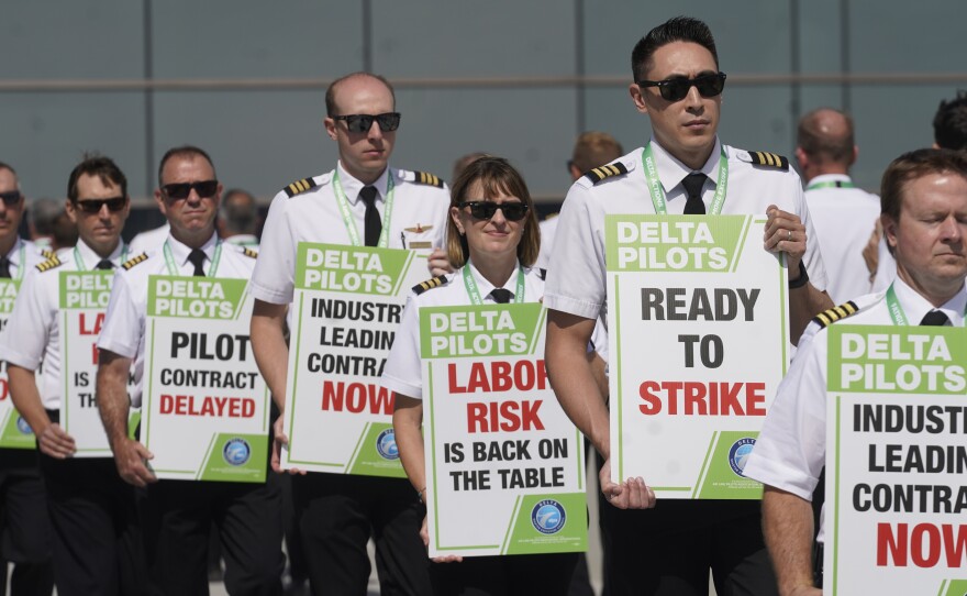 Off-duty Delta Air Lines pilots picket at Salt Lake City International Airport Thursday, June 30, 2022, in Salt Lake City.