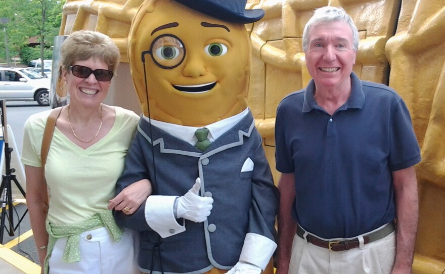 Dashing at any hour, Mr. Peanut refuses to remove the monocle even for this snapshot with one lucky couple.