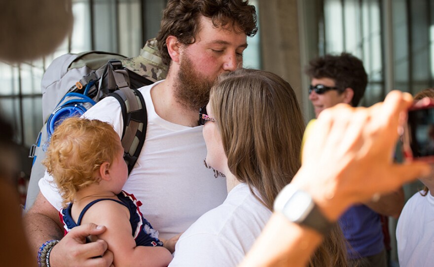 Anthony Anderson kisses his wife Holly and daughter Madeline goodbye.