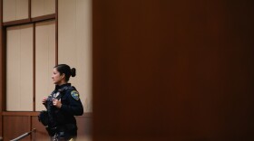 A Chula Vista police officer stands in the City Council chambers during a meeting at City Hall on Jan. 16, 2024.