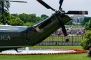 A May Day protest can been seen in front of the Jefferson Memorial with Marine One on the South Lawn of the White House before President Donald Trump departs, Friday, May 1, 2026, in Washington.