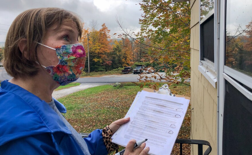 Planned Parenthood volunteer Sarah Mahoney talks to a voter about abortion access outside a home in Windham, Maine on Oct 16, 2021.