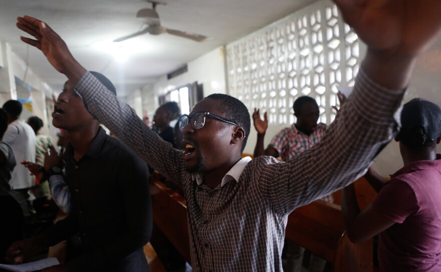 Worshippers gather in the Première Église de Dieu des Cayes, in Les Cayes, Haiti, which sustained cracks from earthquake.