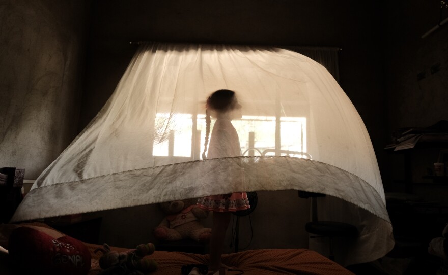 Valeria, age 5, plays behind a curtain at her aunt's house. She is raised solely by her mother. In her region, nearly a third of households are headed exclusively by women. Los Patios, Norte de Santander, Colombia. September 10, 2025.
