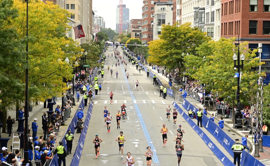 Runners near the finish line on Boylston Street during the 125th Boston Marathon on October 11, 2021 in Boston, Massachusetts. Runners residing in Russia and Belarus are banned from this year's event.