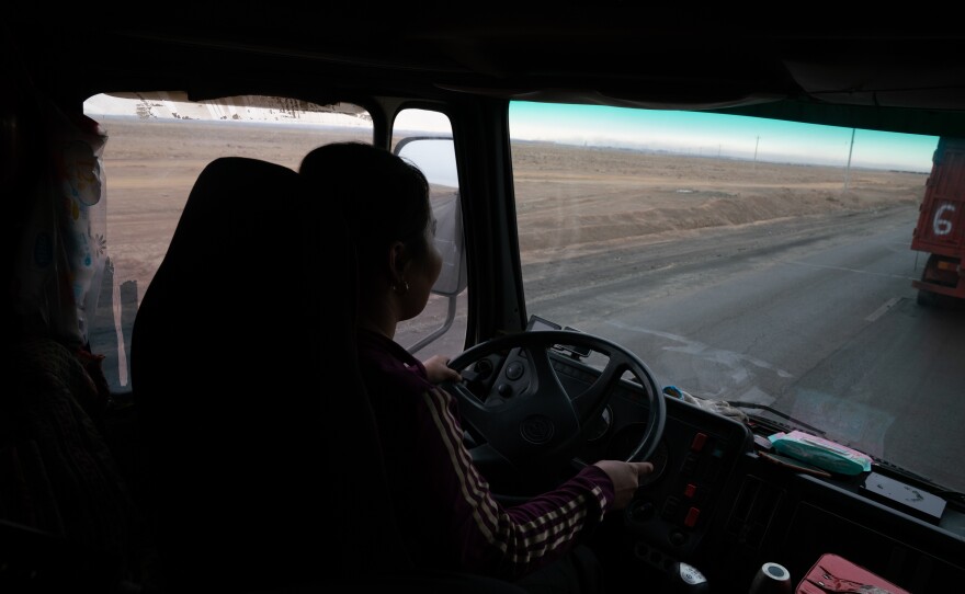 Gulnara Dariiga, 38, drives a truck piled high with coal as she waits to cross the border.  A mining boom in the Gobi Desert is fueling cross-border trade between Mongolia and China, with millions of tons of coal, copper and precious minerals moving by the truckload every year.