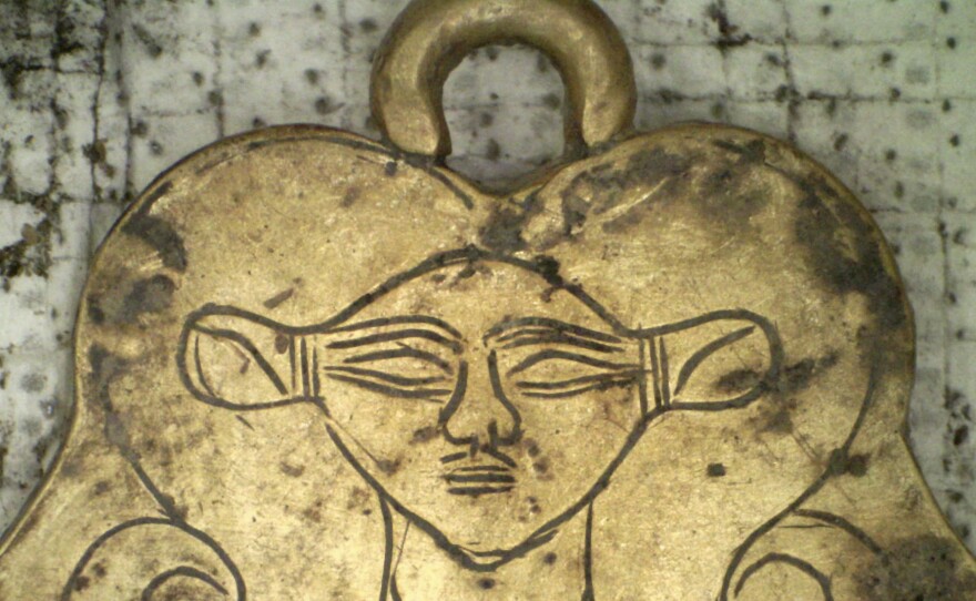 This golden pendant of the Egyptian goddess Hathor was found in one of two 3,500-year-old tombs.