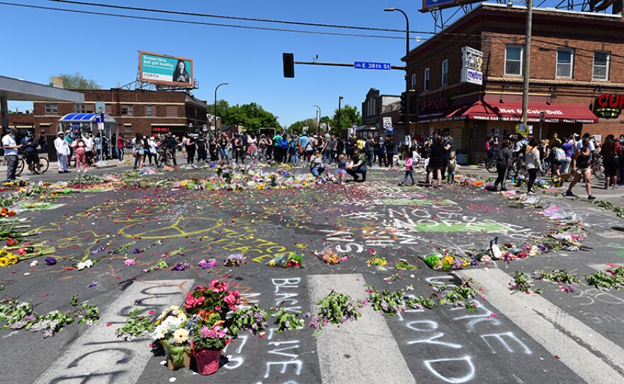 Flowers and slogans in the intersection near where George Floyd was killed, taken in Minneapolis, Minn. May 30, 2020 12:30 p.m. On May 25, Minneapolis Police officers arrested Floyd, handcuffed him, then held him down on his stomach while Derek Chauvin put a knee on his neck as Floyd pleaded for breath. George Floyd died soon after. The four officers at the scene have been fired. Derek Chauvin has been arrested and charged with 3rd degree murder and 2nd degree manslaughter.