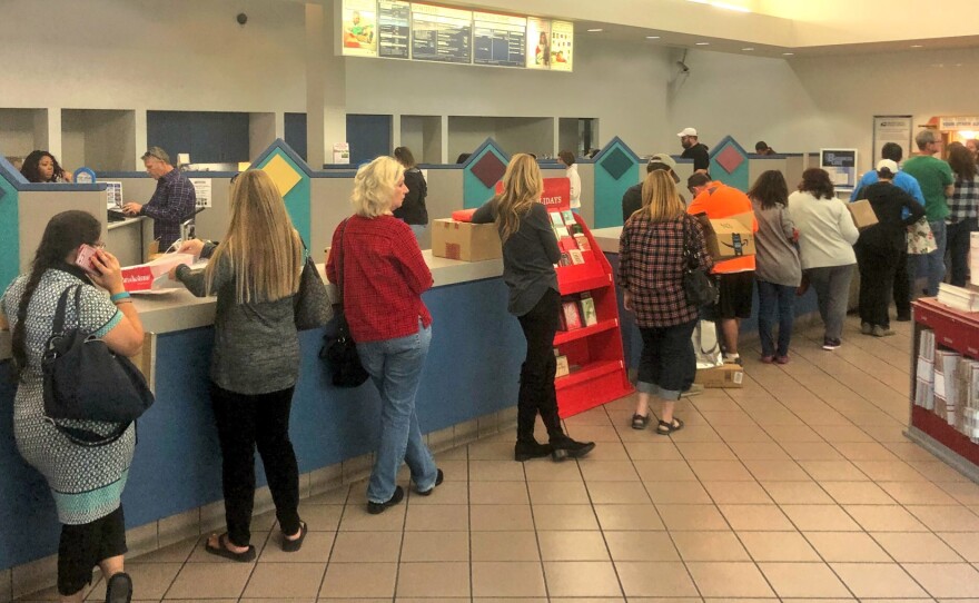People wait in line at the United States Postal Service's Margaret L. Sellers Processing and Distribution Center in Carmel Mountain, Dec. 18 2017.