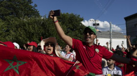 Supporters of Morocco wave flags and cheer during a watch party for the FIFA World Cup match against Brazil in Paterson, N.J. on June 13.