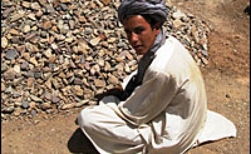 Multan, 15, holds a prayer vigil in front of his brother-in-law's grave. He says the young man was killed by an Afghan army commando, one of more than 90 people killed in the air strike. Multan says the 22 year old had just gotten married a couple of weeks earlier.