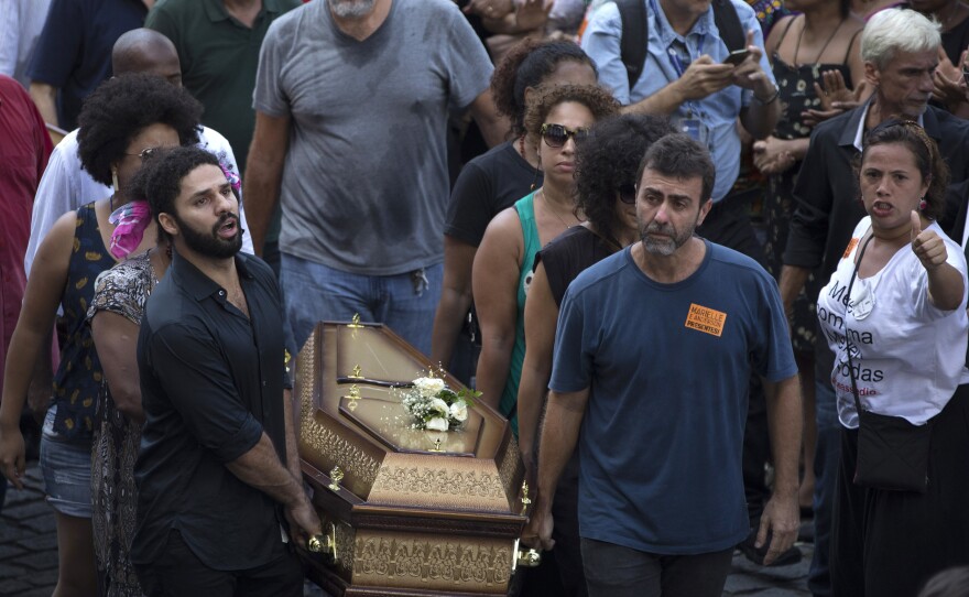 Pallbearers carry coffins containing the remains of Marielle Franco and her driver Anderson Pedro Gomes past a crowd of thousands gathered outside City Hall in Rio de Janeiro on Thursday.