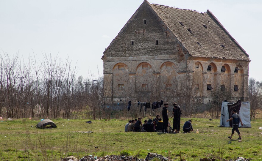 Migrants who don't stay in Serbia's state-run camps sleep in makeshift shelters, abandoned houses or in fields and forests along the borders. Asylum-seekers from Afghanistan sit in an abandoned farm field on the outskirts of the village of Horgos, a few paces away from the border with Hungary. Its proximity to the EU border has made this ruin one of the most popular squats among migrants.