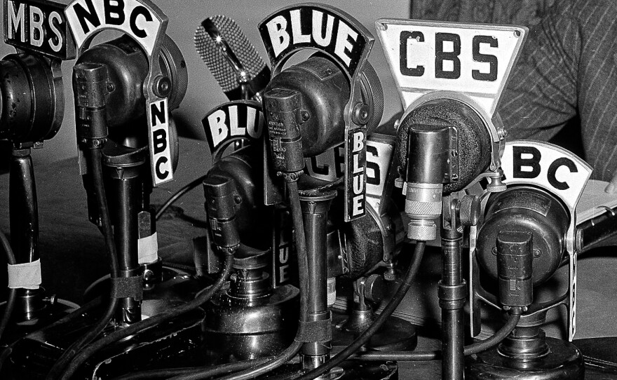 Network microphones on the desk as President Franklin D. Roosevelt addresses the nation from the White House in Washington on April 28, 1942.