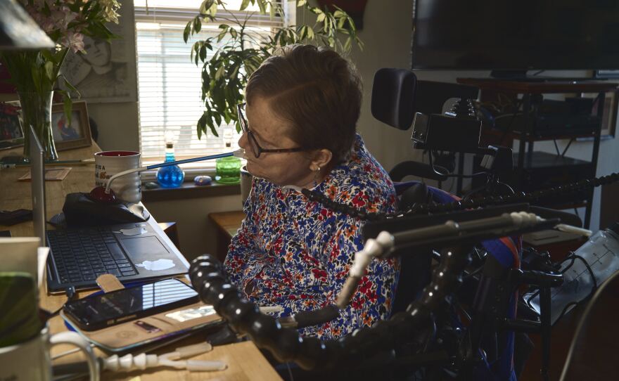 "I'm unable to use my arms or my legs, so I use my mouth to do a lot of things," Chambers says, as she demonstrates the use of assistive devices known as mouth sticks.