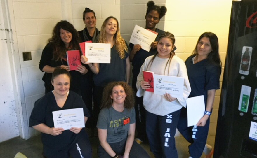 Participants and volunteer instructors of a Poetic Justice writing course celebrate their graduation in December 2019 at San Diego's Las Colinas Detention and Reentry Facility.