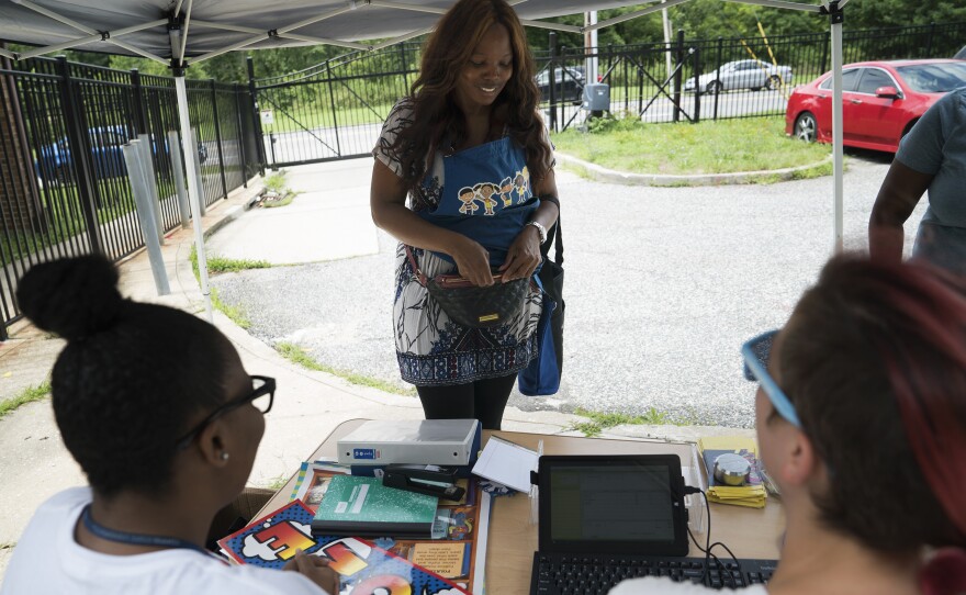 Lauretta Pugh, who teaches 4-and 5-year-olds at Dayspring Head Start, shops the bins outside the Supply Mobile.