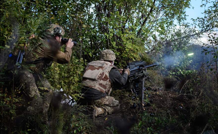 A Ukrainian soldier fires a U.S.-made MK-19 automatic grenade launcher towards Russian positions in the Donetsk region of Ukraine on Oct. 12, 2022.