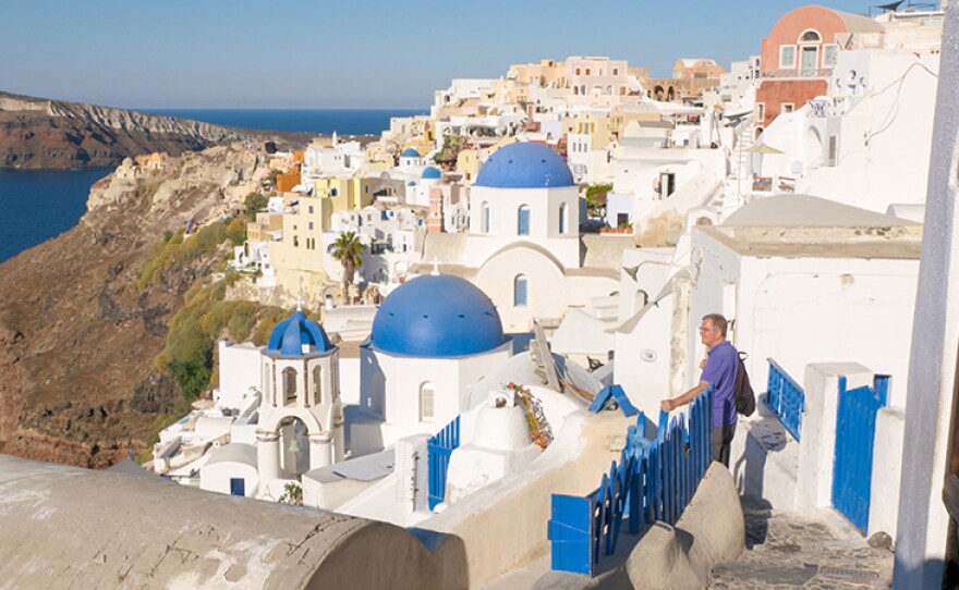 Rick Steves taking in the view from Oia, on Santorini, Greece. 