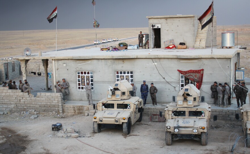 Police meet in the village of Mahana, which was retaken from the Islamic State a few months ago. The police have been training and hope to return to their home city of Mosul soon.
