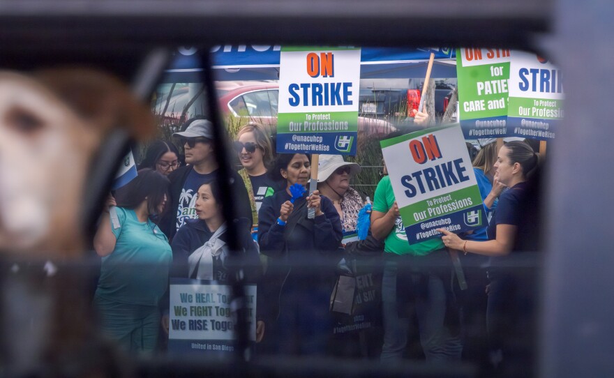 Health care workers strike outside Kaiser's San Diego Medical Center on October 14, 2025.