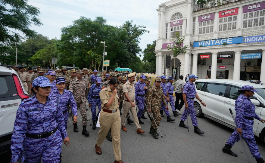 Security personnel patrol ahead of a  tricolor (Indian flag) waving protest called by the youth "Cockroach" movement demanding the resignation of India's election chief in central New Delhi, India, Friday, Oct. 16, 2026.