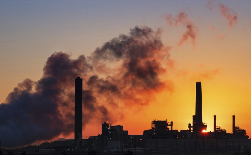 In this July 27, 2018 photo, the Dave Johnson coal-fired power plant is silhouetted against the morning sun in Glenrock, Wyo.