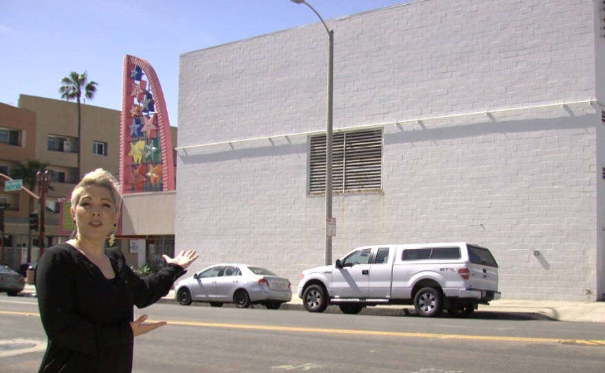 Mitzi Summers points to a large white wall on the side of the Star Theatre that will be the location of the first winning muralist in the Oceanside murals initiative, March 28, 2017.