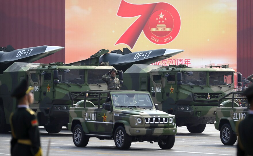 Chinese military vehicles carrying DF-17 ballistic missiles roll during a parade to commemorate the 70th anniversary of the founding of Communist China in Beijing, Tuesday, Oct. 1, 2019.