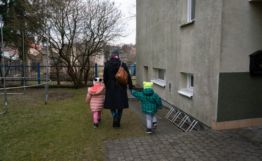 A caretaker at an SOS Children's Village in Bilgoraj, Poland, walks children through the property.