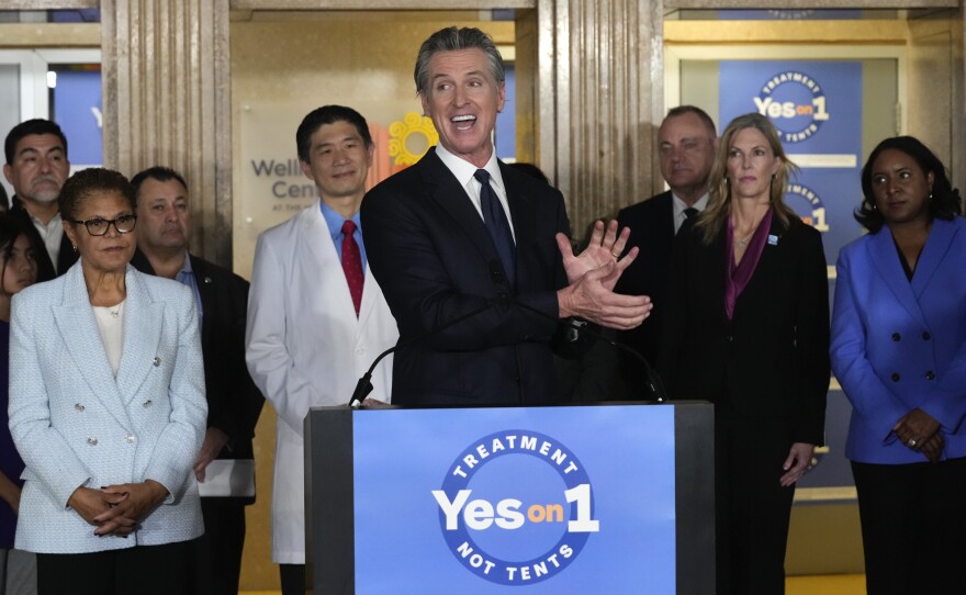 California Gov. Gavin Newsom speaks in support of Proposition 1, a $6.38 billion bond ballot measure, during a news conference at the Los Angeles General Medical Center in Los Angeles, Wednesday, Jan. 3, 2024. California voters have passed the measure that will impose strict requirements on counties to spend on housing and drug treatment programs to tackle the state’s homelessness crisis. Los Angeles Mayor Karen Bass listens at left.