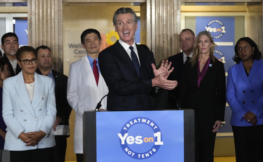 California Gov. Gavin Newsom speaks in support of Proposition 1, a $6.38 billion bond ballot measure, during  a news conference at the Los Angeles General Medical Center in Los Angeles, Wednesday, Jan. 3, 2024. California voters have passed the measure that will impose strict requirements on counties to spend on housing and drug treatment programs to tackle the state’s homelessness crisis.  Los Angeles Mayor Karen Bass listens at left. 