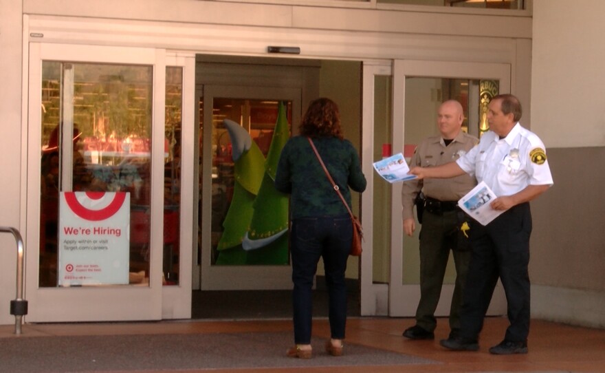 Sheriff's deputies hand out fliers with tips on holiday shopping safety at the Target in Rancho San Diego, Nov. 24, 2015.